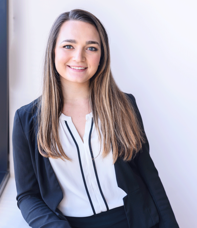 Morgan Morello leaning against a window in her office